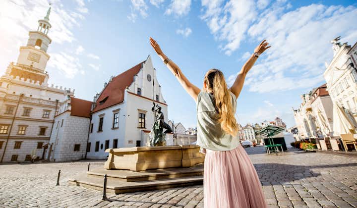 Photo of young woman tourist traveling on the old Market sqaure in Poznan city during the morning light in Poland
