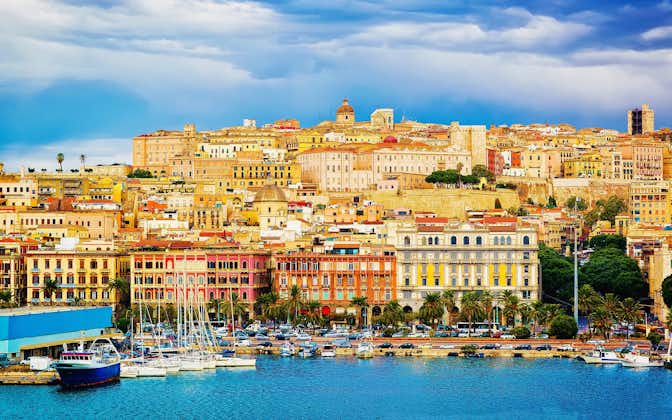 Photo of old Sardinian Port with ships at Mediterranean Sea and city of Cagliari, South Sardinia Island in Italy in summer. 