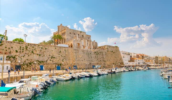 The medieval walled city of Ciutadella de Menorca sits above the Mediterranean port harbor, Spain.