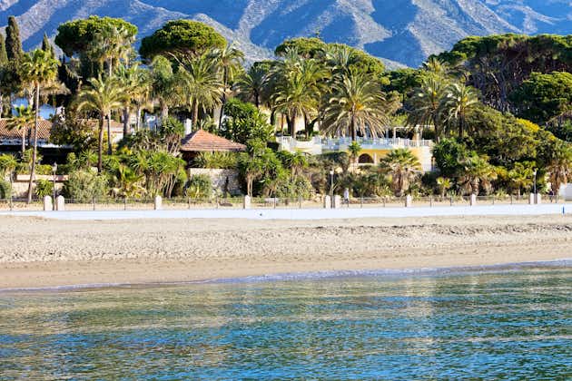 Marbella sandy beach coastline summer holiday scenery by the Mediterranean Sea in Spain, Andalusia region, Costa del Sol, Malaga province.