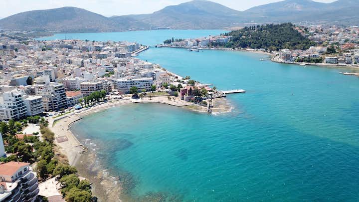 Photo of aerial drone bird's eye view photo from famous city of Chalkida with clear water beach.