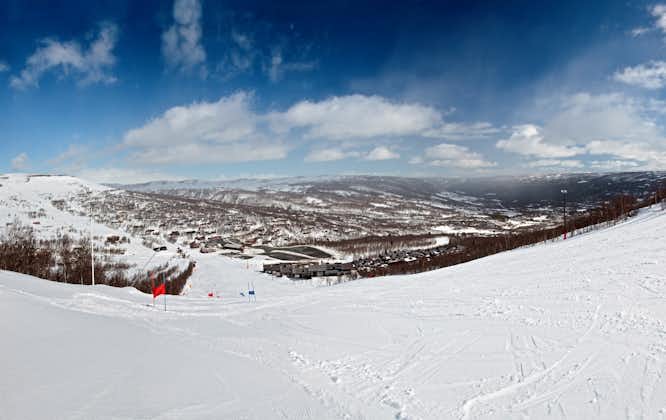 photo of an aerial panorama of ski resort with ski slopes and approaching snowstorm in Geilo, Norway.