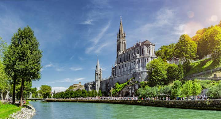 Gave de Pau river beside the Basilica Notre Dame in Lourdes, France