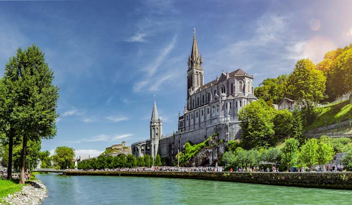 Gave de Pau river beside the Basilica Notre Dame in Lourdes, France