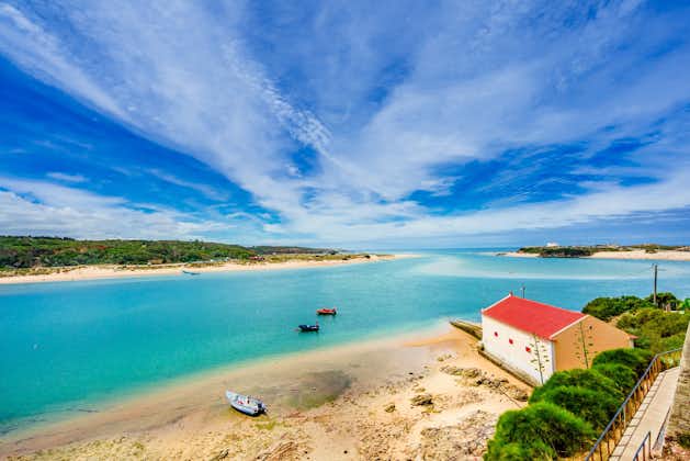 Breathtaking view of the mouth of the River Mira flowing into the Atlantic Ocean - Aquatic lifestyle sport in idyllic turquoise water, Vila Nova de Milfontes, Vicentine Coast Natural Park PORTUGAL