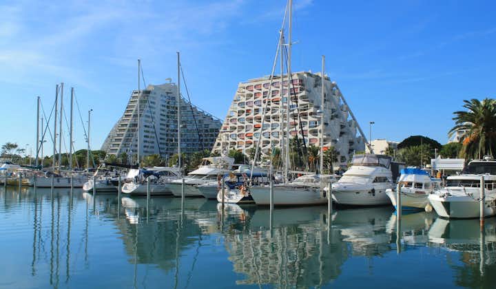 Pyramids buildings and pleasure boats in the seaside resort and marina of la Grande Motte in Herault department, France