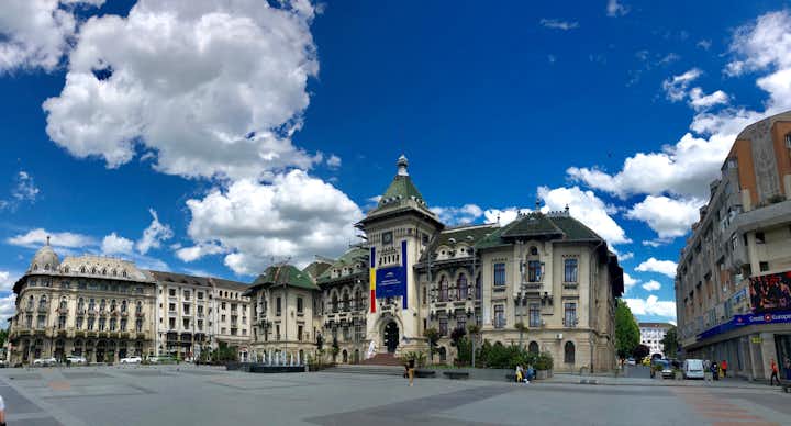 Photo of Administrative Palace from Craiova Romania during summer sunny day with blue sky and white clouds.