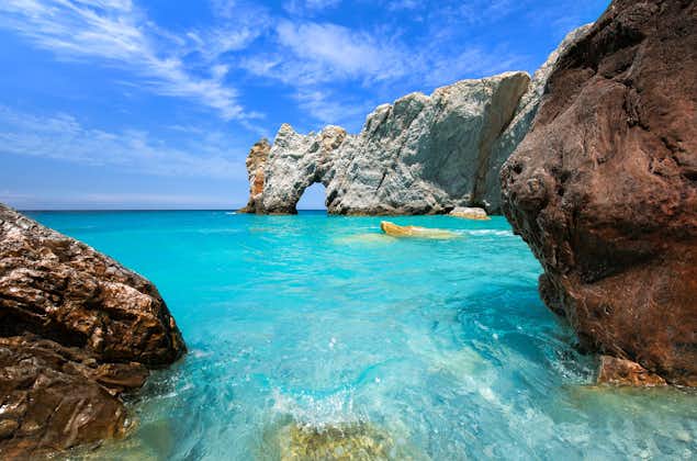 Photo of Lalaria beach in Skiathos with turquoise clear waters and two big rocks in the foreground.