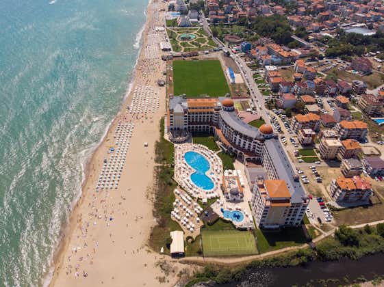 Aerial photo of the beautiful small town and seaside resort known as Obzor in Bulgaria showing the coastal hotels and people relaxing and having fun on the golden sunny beach of the Black Sea coast