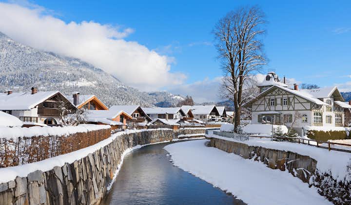 Photo of Loisach river flowing through Garmisch-Partenkirchen covered with snow, idyllic winter landscape bavaria