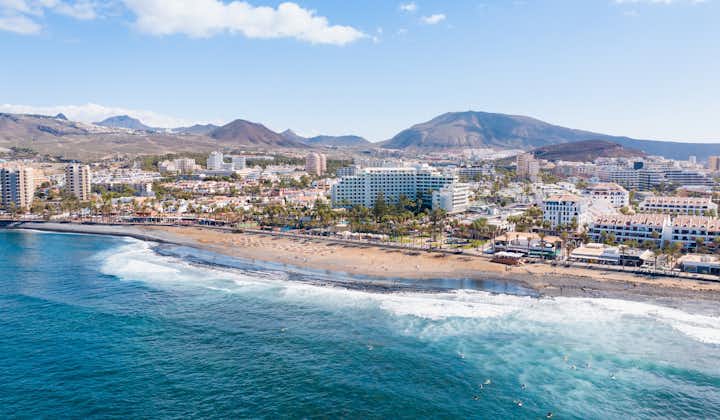 Photo of aerial view of Playa de las Americas area, Tenerife, Spain with amazing ocean landscape and lots of hotels and restaurants.