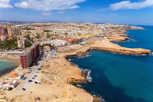 Aerial drone point of view rocky coastline of spanish tourist resort town of Torrevieja, Spain.