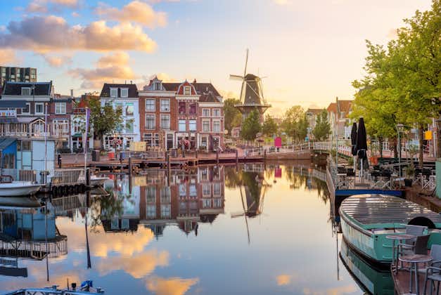 photo of Leiden Old town cityscape, view of the Beestenmarkt and the De Valk mill reflecting in Rhine river on sunrise, South Holland, Netherlands.