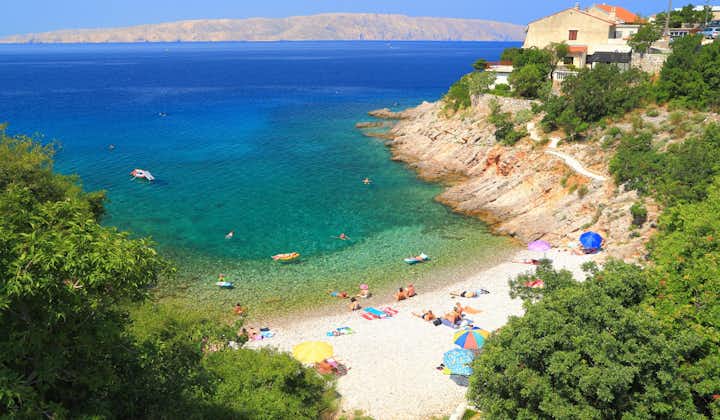 photo of  Pláž Senj it's a small beach hidden by vegetation near the Adriatic Sea, Senj, Croatia.