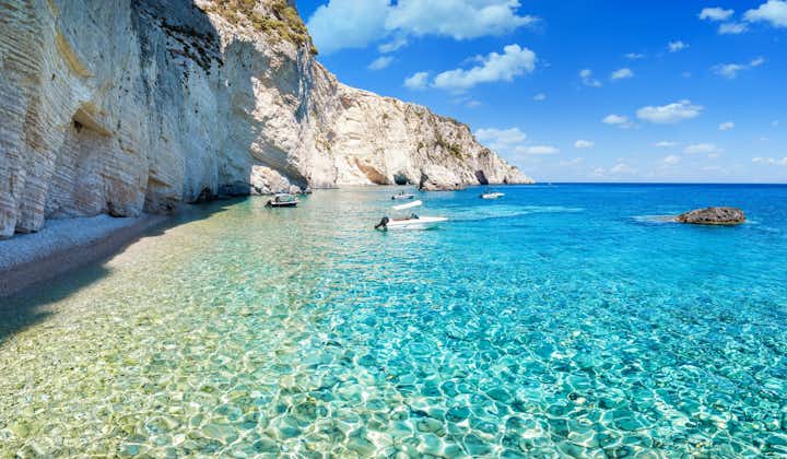 Photo of shining turquoise sea next to the steep cliffs at the Ionian island of Zakynthos Laganas bay, Greece