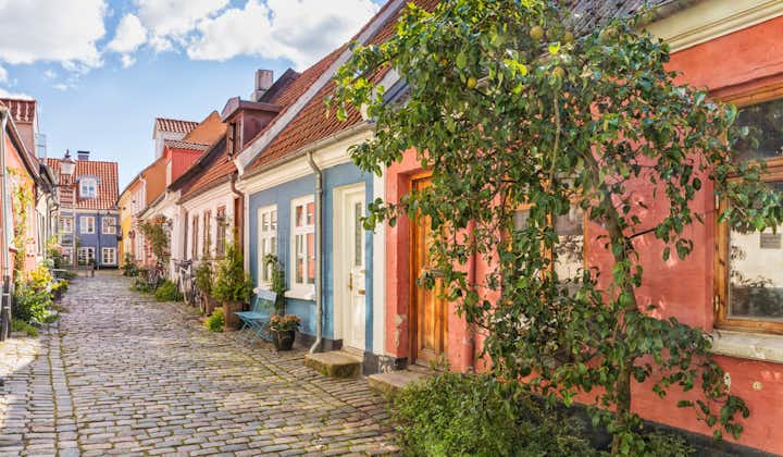 Photo of An idyllic cobbled street with colorful houses at the old town of Aalborg, Denmark.
