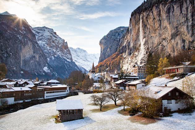 photo of amazing touristic alpine village in winter with famous church and Staubbach waterfall Lauterbrunnen Switzerland.