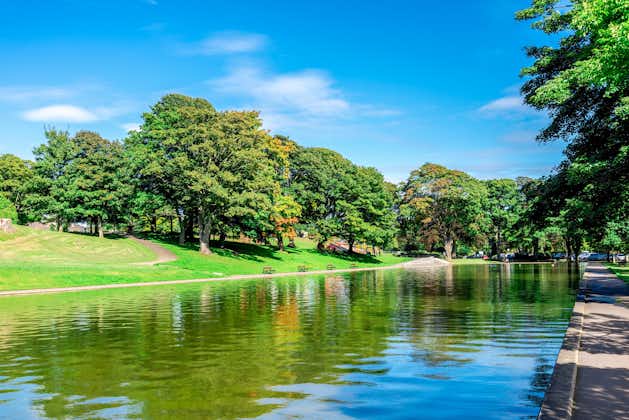 Photo of long pond and an alley in Duthie park near the entrance, Aberdeen, Scotland.