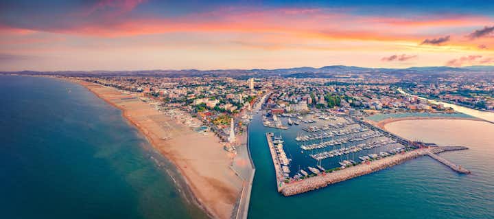 Photo of Panoramic summer view from flying drone of Libera Rimini public beach. Captivating evening scene of Italy, Europe. Colorful sunset on Adriatic coast. Vacation concept background.