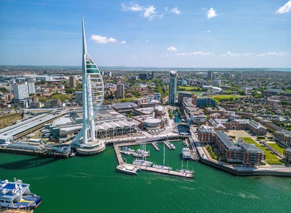 Photo of aerial view of Spinnaker Tower and Portsmouth Harbour. Portsmouth is a port city and unitary authority in Hampshire, England.
