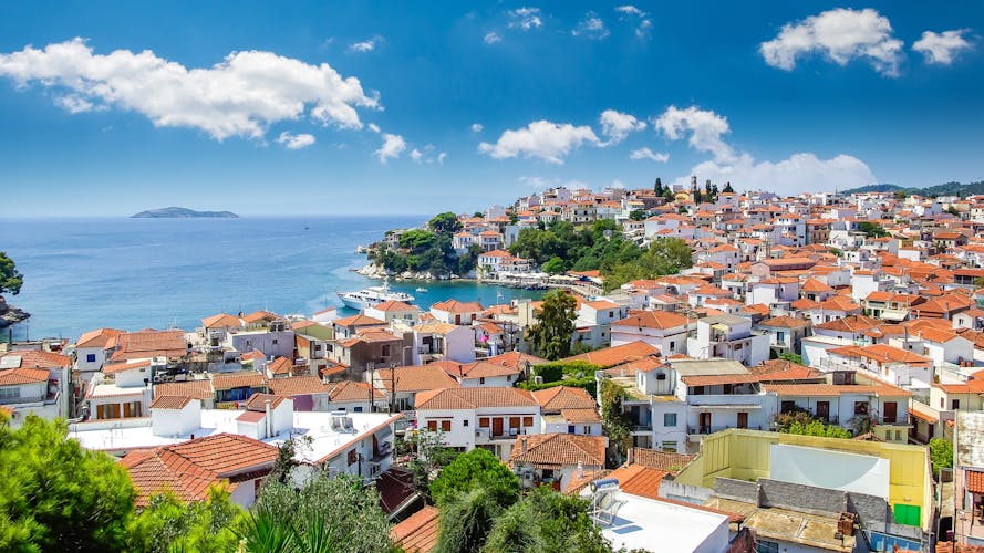 Photo of Skiathos town, beautiful view of the old town with boats in the harbor.