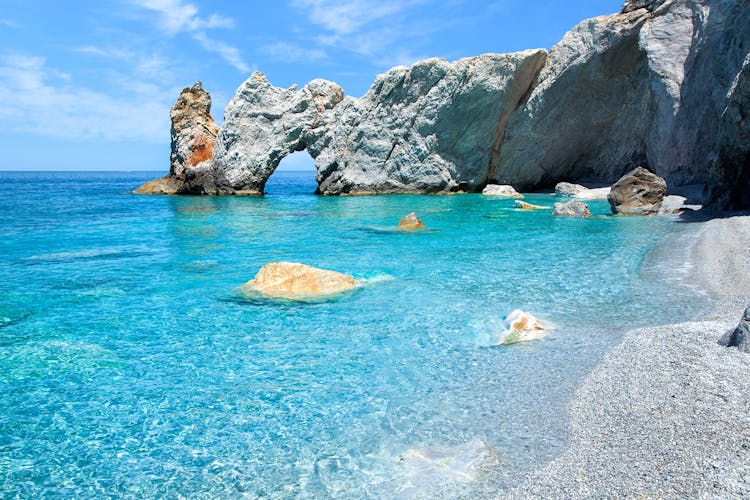 Photo of the famous rock with a hole in Lalaria Beach, Skiathos.