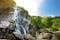 Majestic water cascade of Powerscourt Waterfall, the highest waterfall in Ireland. Famous tourist atractions in co. Wicklow, Ireland.