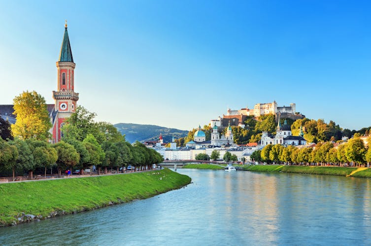 Photo of beautiful view of Salzburg skyline with Festung Hohensalzburg and Salzach river in summer.