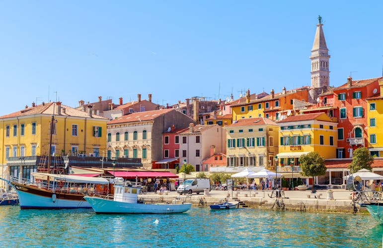 Photo of Colorful Rovinj in Istria with boats in the port, Croatia.