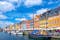 Photo of Scenic summer view of Nyhavn pier with colorful buildings and boats in Old Town of Copenhagen, Denmark.