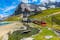 Photo of Cogwheel red passenger train in the small mountain station. Small train station on the shore of the Fallbodensee lake, Jungfraujoch, Bernese Oberland, Switzerland.