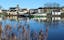 Photo of Carrick-on-Shannon, County Leitrim, Ireland viewed from across River Shannon against backdrop of blue sky.
