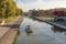 photo of La Villette Park with the Canal of the Basin of the Villette with boat at beautiful morning in Paris, France.