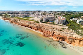 Photo of aerial panoramic view coastline and La Vila Joiosa Villajoyosa touristic resort townscape, sandy beach and Mediterranean seascape, Costa Blanca, Spain.