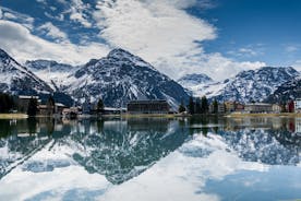 photo of beautiful snow capped mountains with Arosa village in France. Back country skier in the foreground leave their tracks in the deep snow.