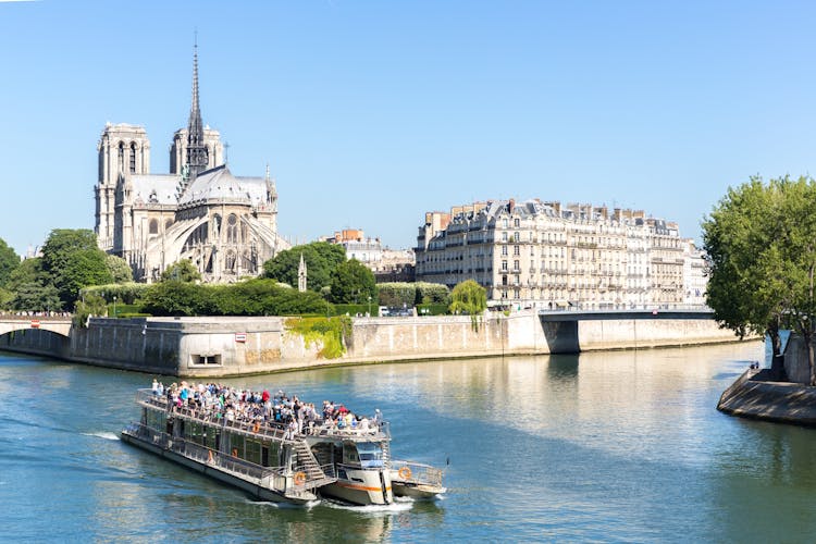 Photo of tourist cruise in River Seine Paris with Cathedral Notre Dame Reims Champagne