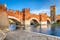 photo of view of Verona, Italy. Scenery with Adige River and Ponte Scaligero and Castelvecchio, medieval landmarks of veronese city, Verona, Italy.