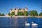 View of the Schwerin medieval castle from the lake with swans, Germany.