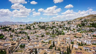 Photo of aerial view of Jaen with cathedral and Sierra Magina mountains on background, Andalusia, Spain.