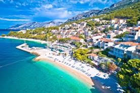 Photo of panorama and landscape of Makarska resort and its harbour with boats and blue sea water, Croatia.