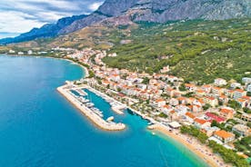 Photo of panorama and landscape of Makarska resort and its harbour with boats and blue sea water, Croatia.