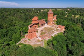 Photo of aerial view of an old stone castle ruins in Koknese, Latvia, on a peninsula near the Daugava river and Perse river.