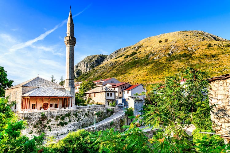 Mostar, Bosnia and Herzegovina. Morning summer light on the Old City with medieval Ottoman Mosque and minaret.