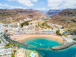 photo of landscape with Maspalomas town and golden sand dunes at sunrise, Gran Canaria, Canary Islands, Spain.