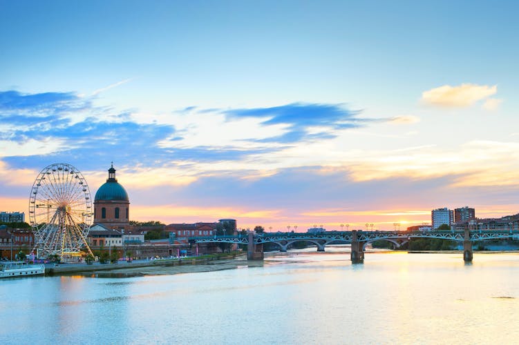 Photo of Toulouse landmarks on the bank of river Garone at sunset. France.