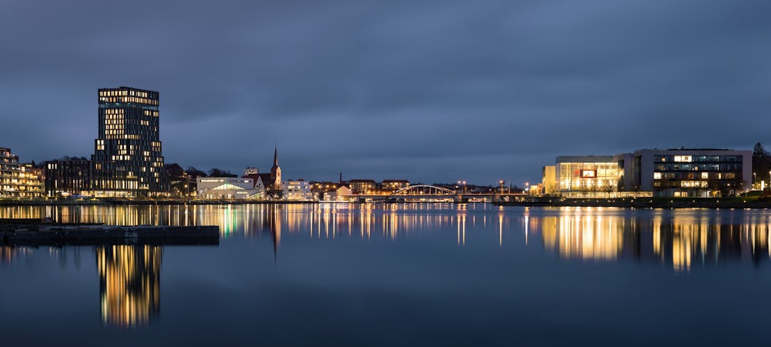 Evening cityscape of Sonderborg (Dan. Sønderborg), city in Southern Denmark. Night skyline city lights wide panorama
