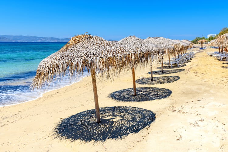 Photo of parasols on Agia Anna beach, one of the best organized beaches of Naxos. Cyclades Islands, Greece.