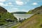 Photo of the waters flowing over the top of the main dam at Caban Coch dam in the Elan valley of Wales.