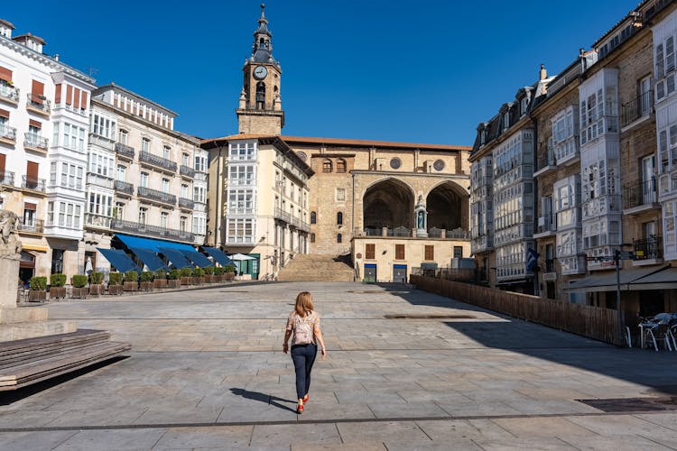 Photo of Tourist woman walking through the large Plaza de la Virgen Blanca in the city of Vitoria, Spain.