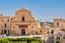 Photo of Italy Piazza Maggiore in Bologna old town tower of town hall with big clock and blue sky on background, antique buildings terracotta galleries.